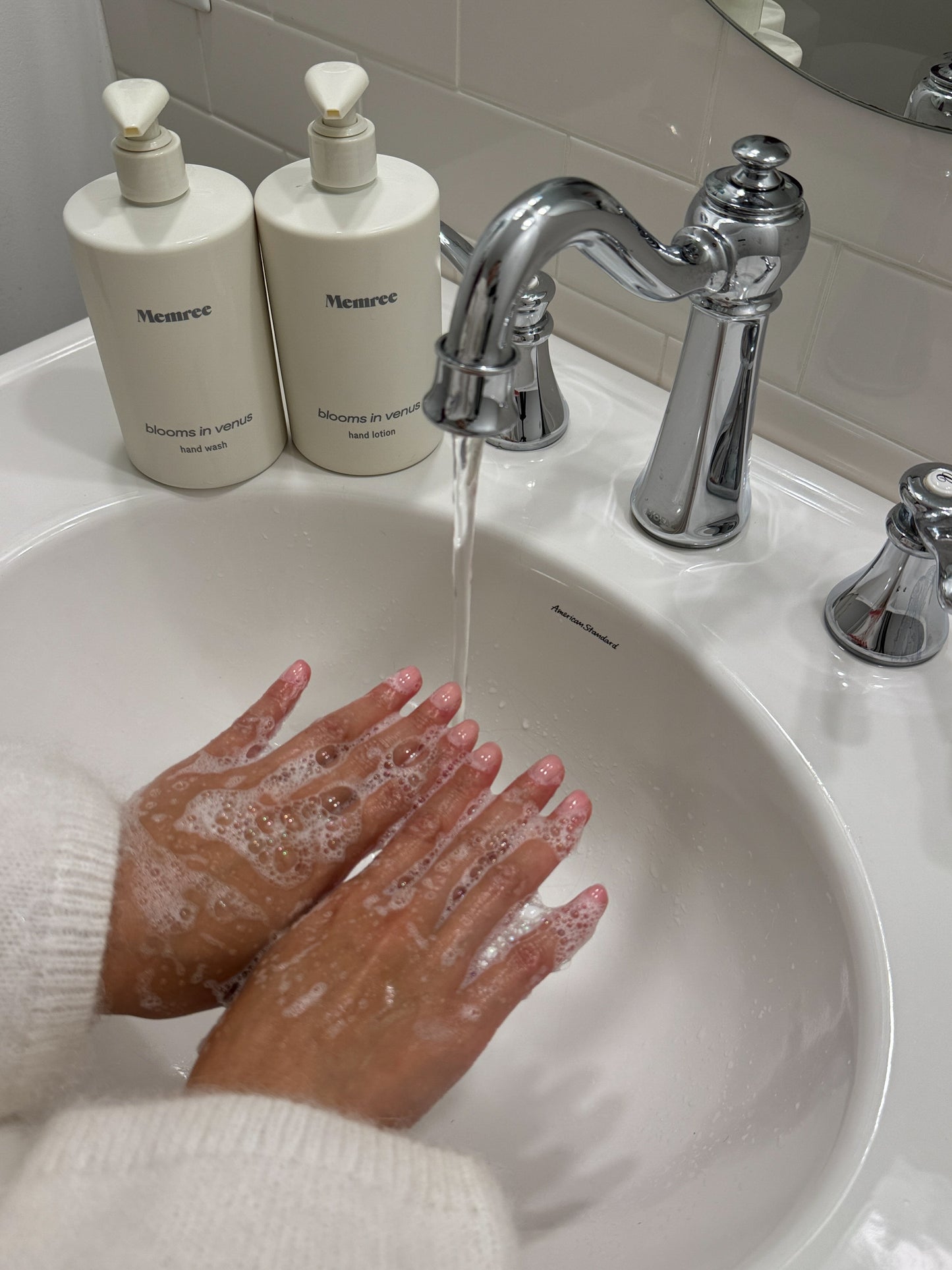 Hands in a white sink showing the bubbles of Memree Handwash