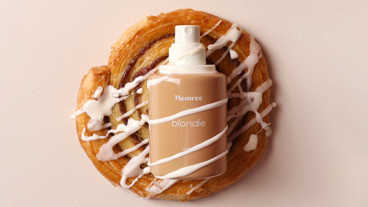 Memree extrait de parfum bottle photographed in warm, low light