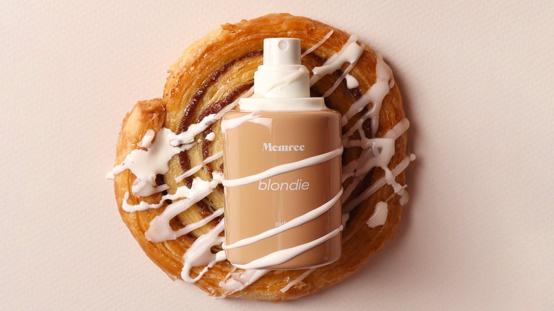 Memree extrait de parfum bottle photographed in warm, low light