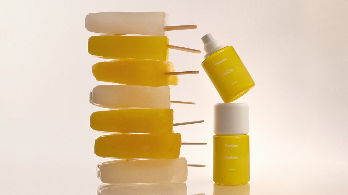 Two parfum bottles stacked beside a column of frozen ice lollies